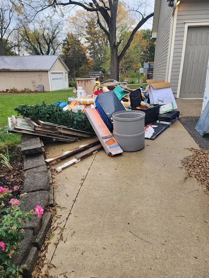 Dumpster being loaded with debris for 12 Yard Dumpster Rental in Fox Island